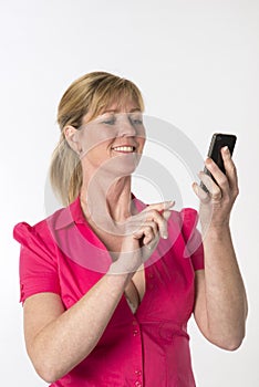 Woman dialling a number on a mobile phone photo