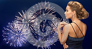 Woman with diamond earring over firework