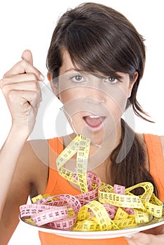 Woman diet eating a tape mesure