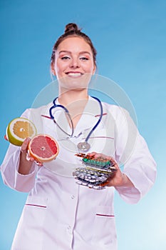 Woman with diet weight loss pills and grapefruits.