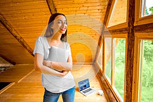 Woman with digital tablet in wooden house