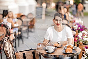 A woman dines in a street cafe