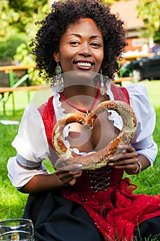 Woman in Dirndl with Bavarian Pretzl