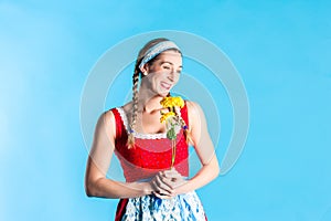 Woman in dirndl dress holding flowers