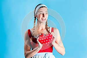 Woman in dirndl dress opening gift