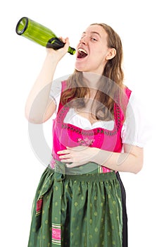 Woman in dirndl drinking some bottles of wine