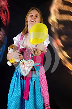 Woman in dirndl enjoying fun fair
