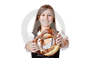 Woman with dirndl holding Oktoberfest pretzel