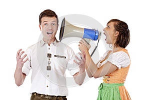 Woman in dirndl screams to man in megaphone
