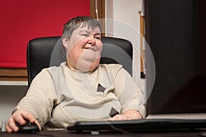 woman with a disability develop sitting at the computer, alternative Therapy photo