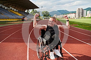 A woman with disability in a wheelchair showing dedication and strength by showing her muscles