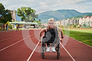 A woman with disablity driving a wheelchair on a track while preparing for the Paralympic Games