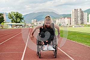 A woman with disablity driving a wheelchair on a track while preparing for the Paralympic Games