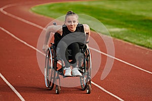 A woman with disablity driving a wheelchair on a track while preparing for the Paralympic Games