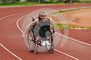 A woman with disablity driving a wheelchair on a track while preparing for the Paralympic Games