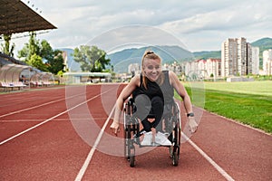 A woman with disablity driving a wheelchair on a track while preparing for the Paralympic Games