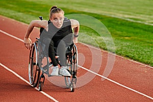 A woman with disablity driving a wheelchair on a track while preparing for the Paralympic Games