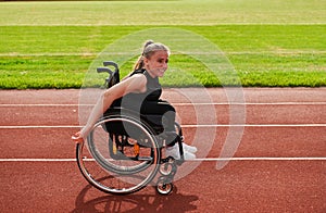 A woman with disablity driving a wheelchair on a track while preparing for the Paralympic Games