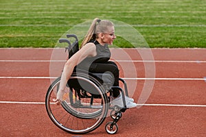 A woman with disablity driving a wheelchair on a track while preparing for the Paralympic Games