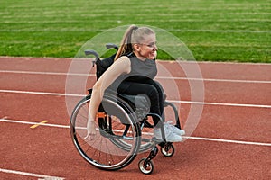 A woman with disablity driving a wheelchair on a track while preparing for the Paralympic Games