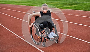 A woman with disablity driving a wheelchair on a track while preparing for the Paralympic Games