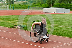 A woman with disablity driving a wheelchair on a track while preparing for the Paralympic Games