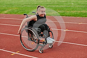 A woman with disablity driving a wheelchair on a track while preparing for the Paralympic Games