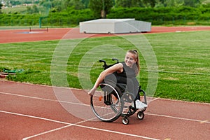 A woman with disablity driving a wheelchair on a track while preparing for the Paralympic Games