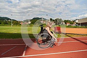 A woman with disablity driving a wheelchair on a track while preparing for the Paralympic Games