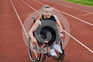 A woman with disablity driving a wheelchair on a track while preparing for the Paralympic Games