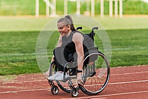 A woman with disablity driving a wheelchair on a track while preparing for the Paralympic Games