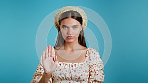 Woman disapproving with NO hand make negation gesture. Denying, Rejecting, Disagree, Portrait of Beautiful lady on blue