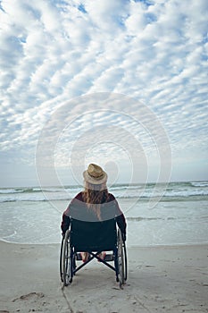 Woman disbale sitting on wheelchair at beach