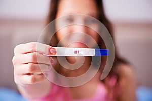 The woman discovering her positive pregnancy test