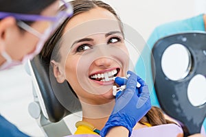 Woman discussing dental bleaching with her dentist photo