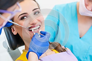 Woman discussing dental bleaching with her dentist photo