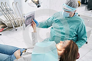 Woman discussing dental scan with doctor in stomatology clinic