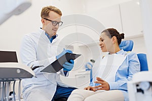 Woman discussing diagnosis with dentist in office