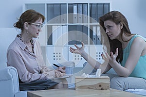 Woman discussing with psychologist