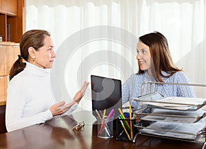 Woman discussing something with young girl