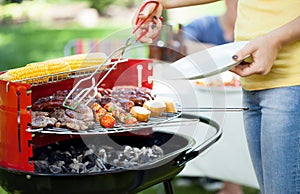 Woman dishing up grilled meals