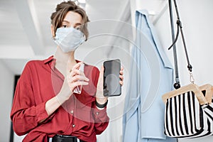 Woman disinfecting mobile phone