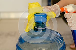 The woman disinfects the carboy