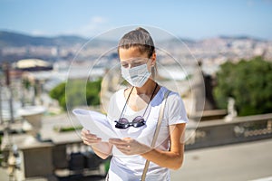Woman in disposable face mask observing sightseeings