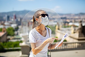 Woman in disposable face mask observing sightseeings