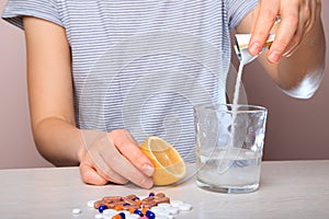 Woman dissolves medicine with soluble sachet in water. Soluble powder drug dissolved in water. headache, toothache