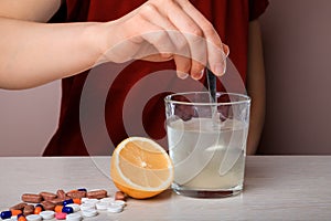 Woman dissolves medicine with soluble sachet in water. Soluble powder drug dissolved in water. headache, toothache