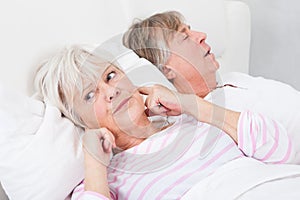 Woman disturbed with man snoring