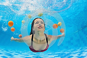 Woman dive underwater in swimming pool