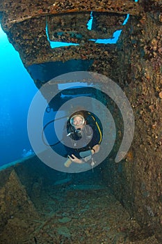 Woman diver on ship wreck